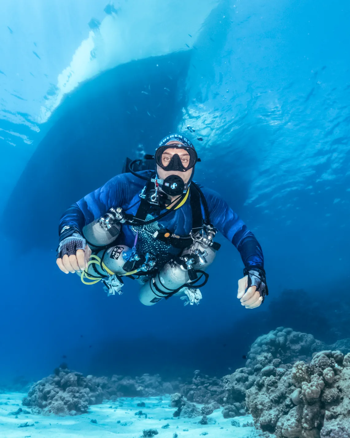Sidemount technical diver over a Red Sea reef