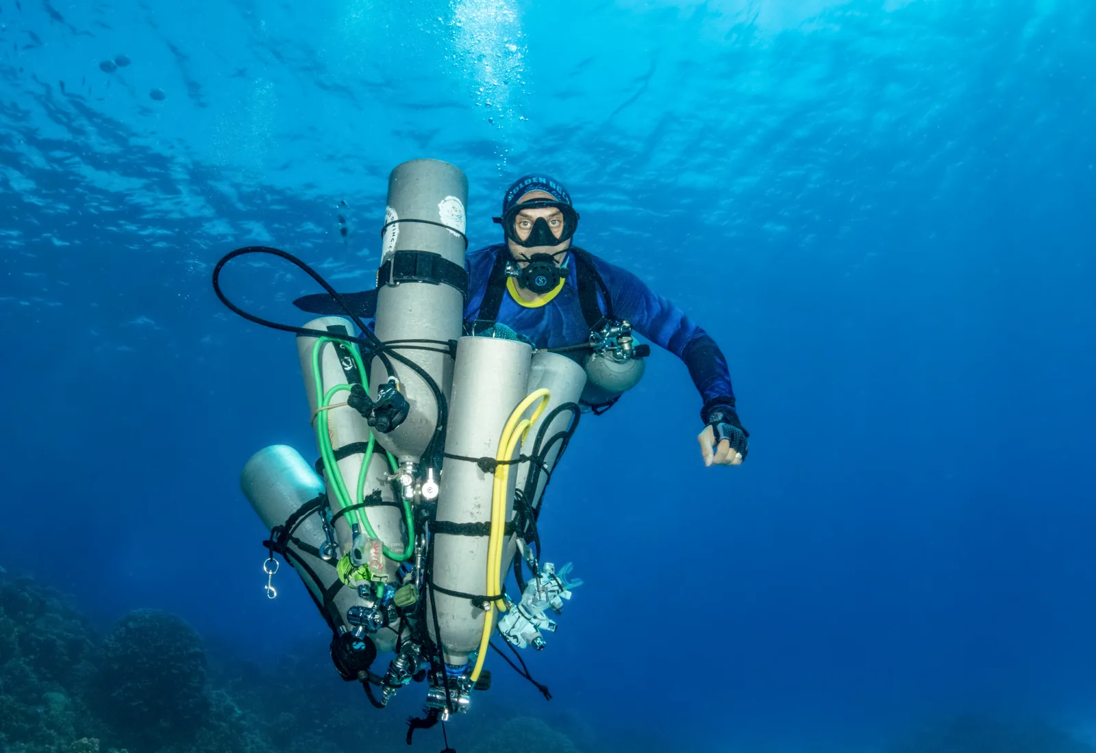Technical diver managing trimix stage cylinders in the Red Sea